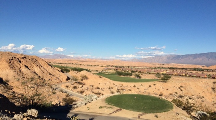 Golf green surrounded by red desert rock at Conestoga Golf in Mesquite, Nevada