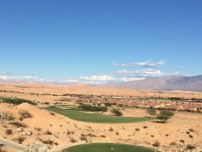 Golf green surrounded by red desert rock